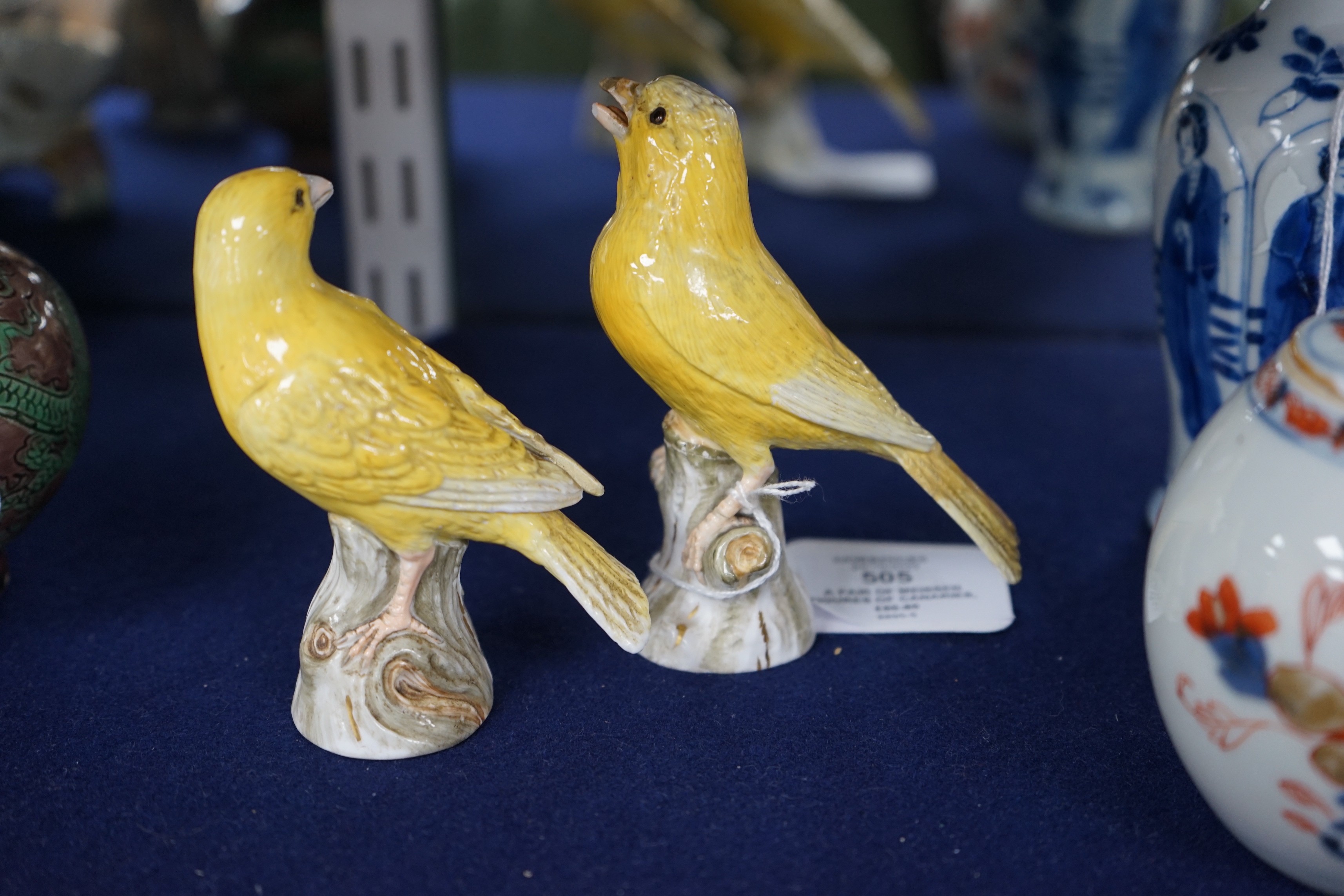A pair of Meissen figures of canaries, 10cm tall